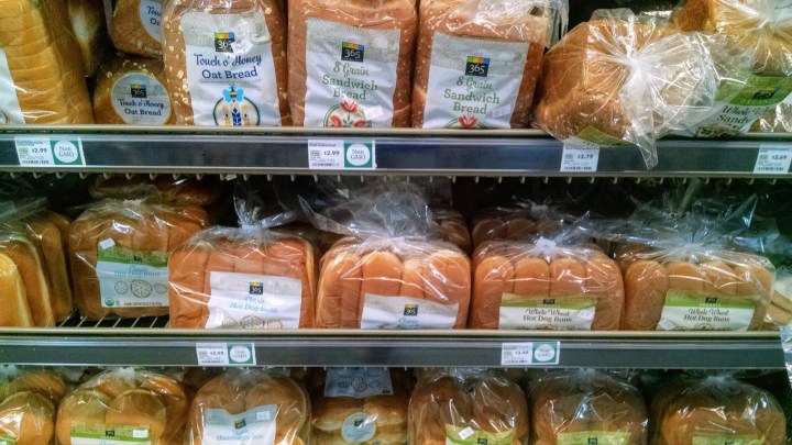 rows of multigrain breads and buns