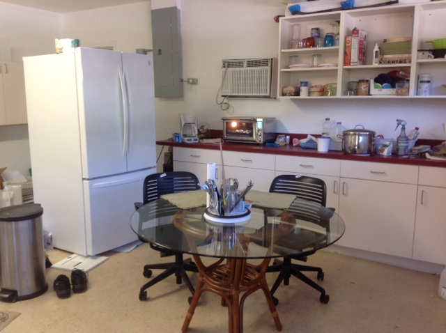 refrigerator kitchen table and cabinets in the garage