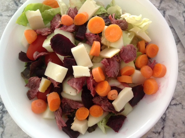 vegetables, meat and cheese on a salad plate