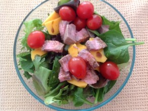 vegetables, meat and cheese in a salad bowl