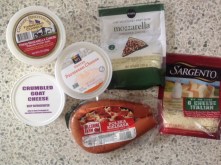 packages of cheese and sausage in plastic packages.