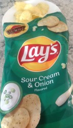 bag of potato chips poured out on a dinner plate