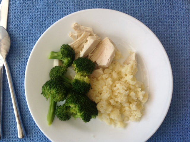 plate of chicken, broccoli and diced cauliflower