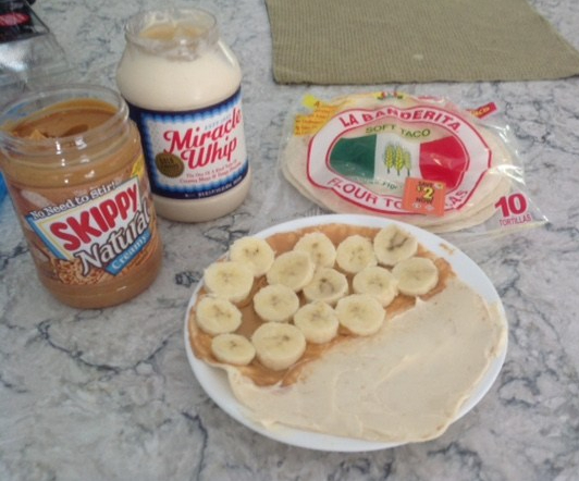 burrito shell half covered with peanut butter, mayonnaise, and banana slices