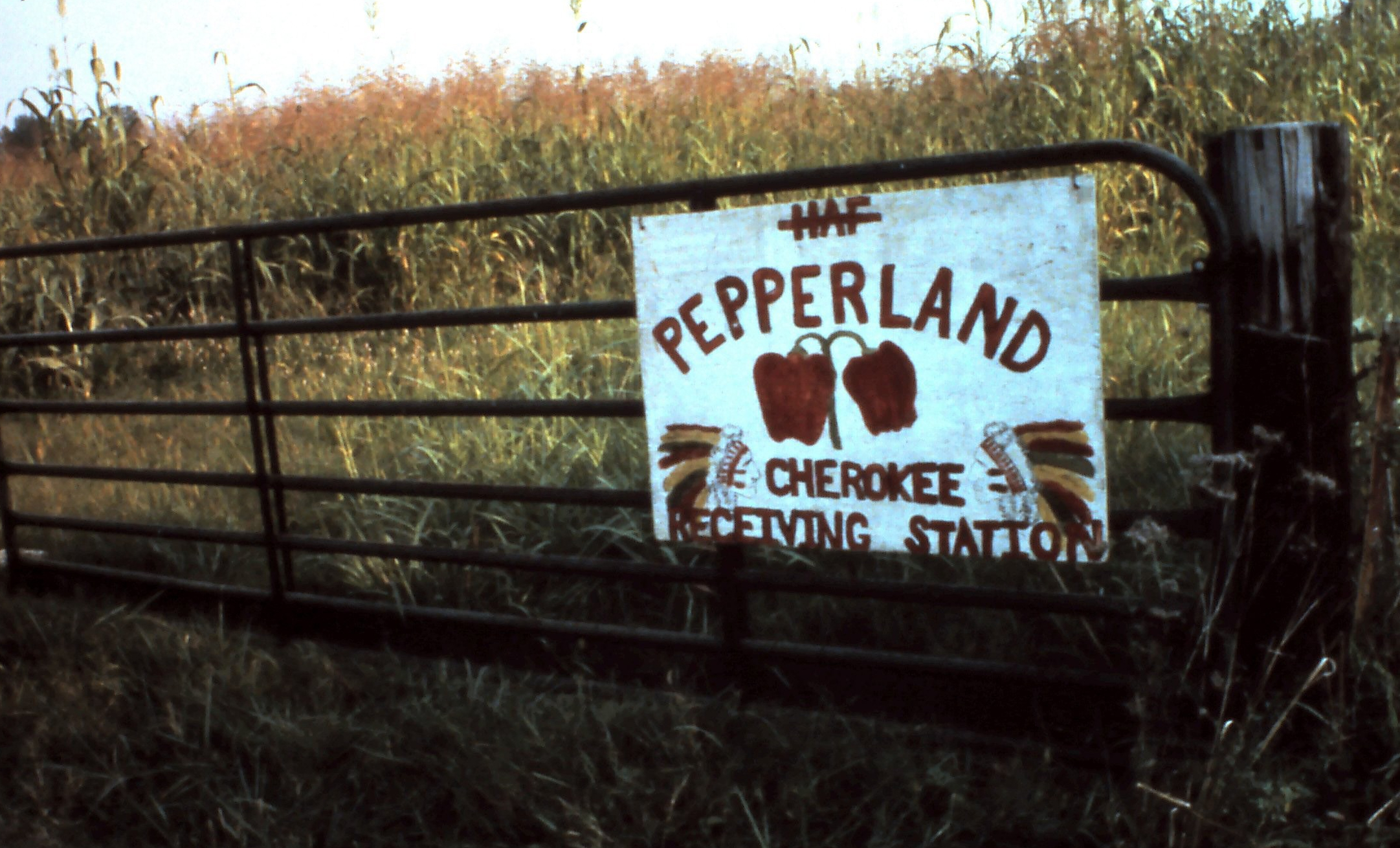 sign on a farm gate: Pepperland Cherokee Receiving Station