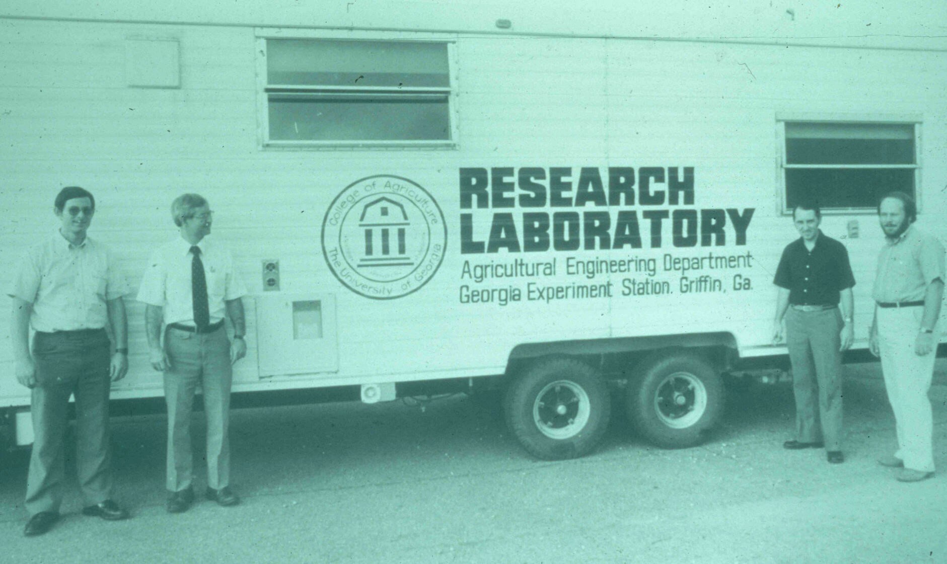 postharvest systems research team posing in front of the mobile lab