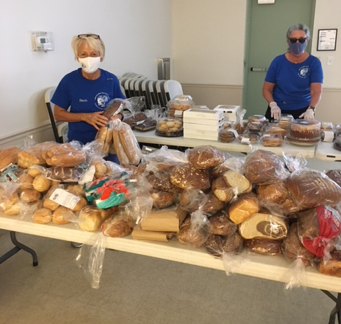 masked ladies at the bread and dessert tables