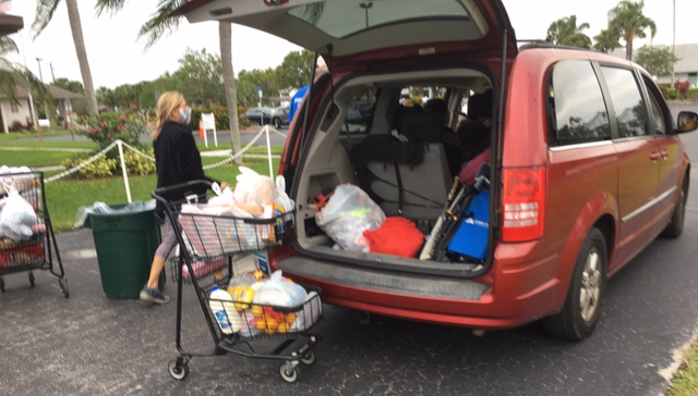 SUV with hatchback open prior to loading a basket full of food.