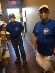 two men with masks in the first aisle of the pantry