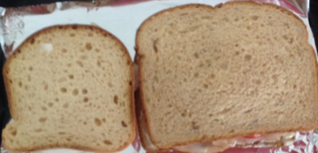 Two sandwiches compared. The smaller one was made with gluten free bread. h