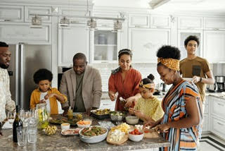 Black family filling their plates around a kitchen island