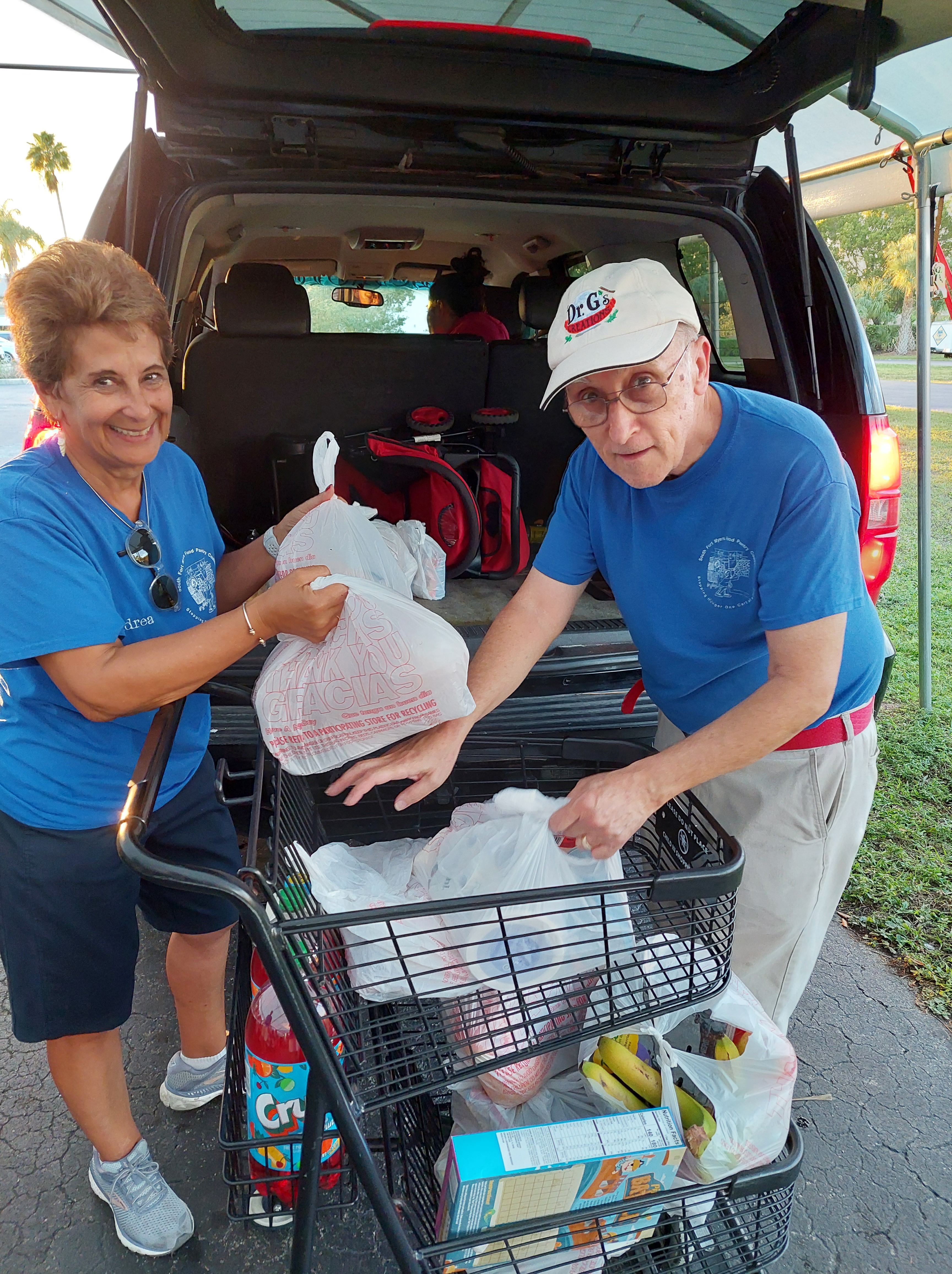 loading bags of food into a SUV