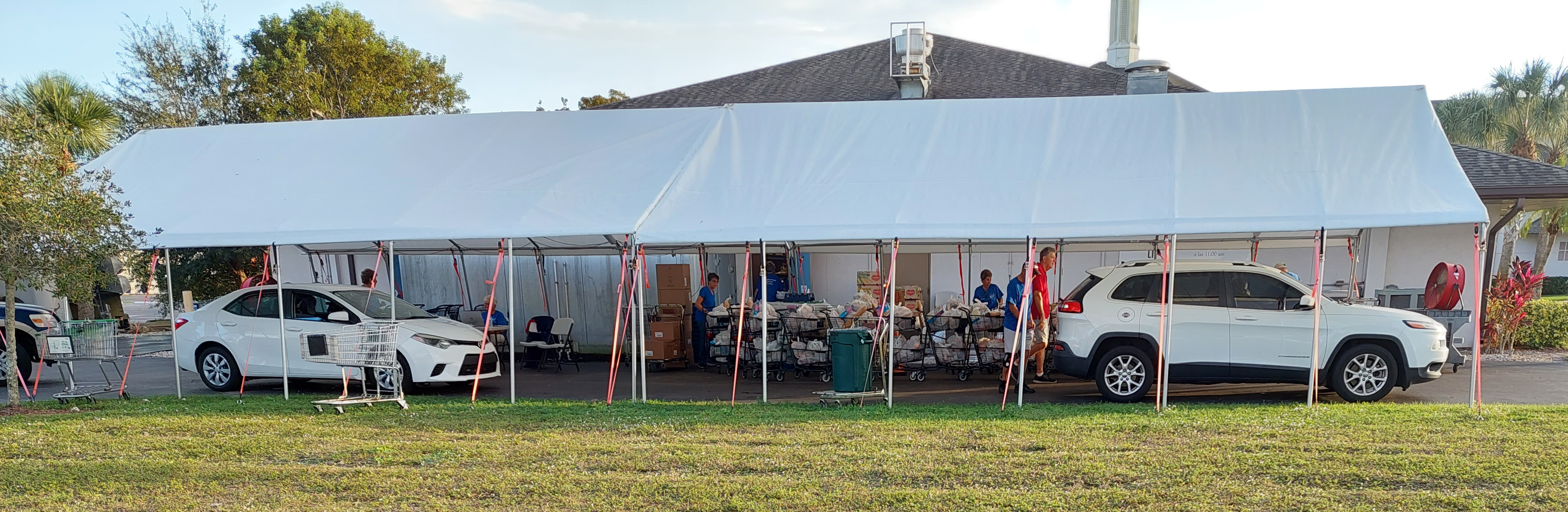 two vehicles in the tented area for registration and loading