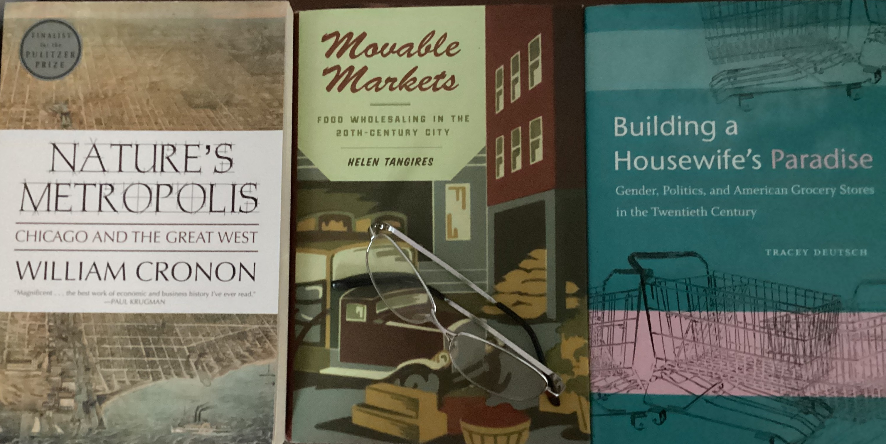 Photo of three book covers: Nature's Metropolis, Moveable Markets, and Building a Housewife's Paradise